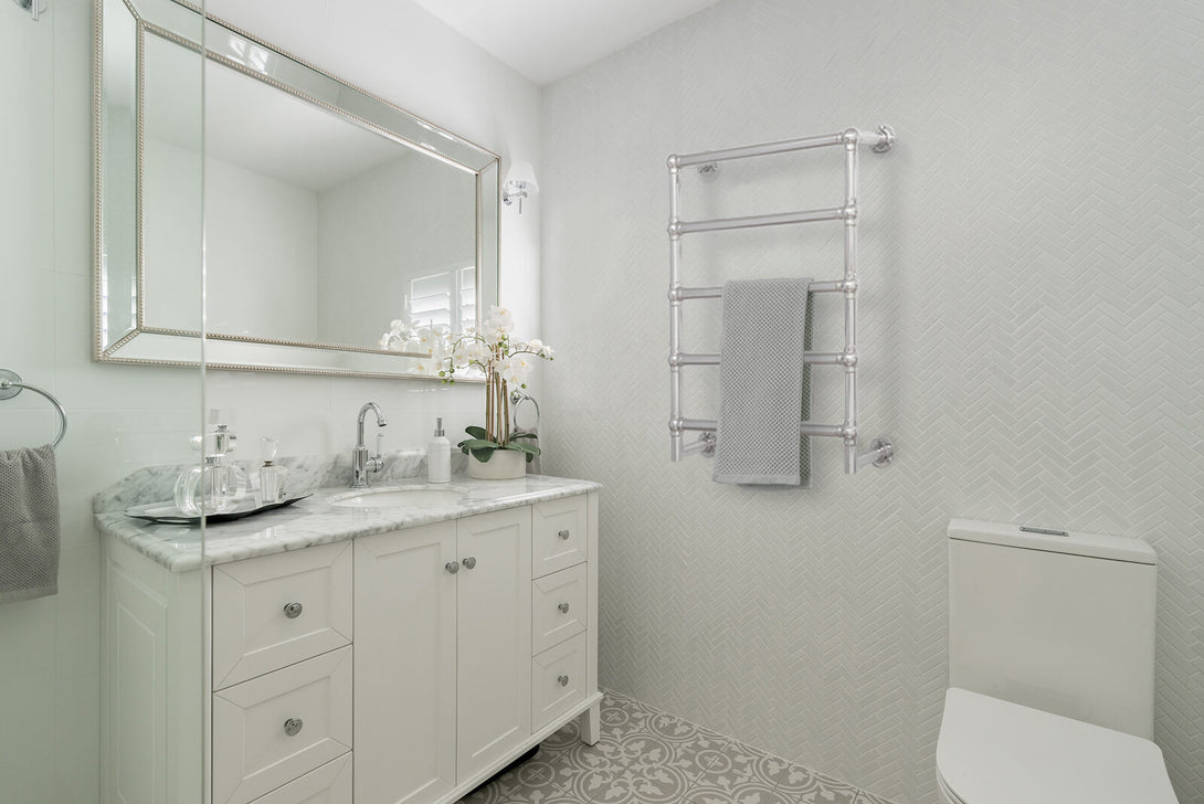 A Mayer Heated Towel Ladder next to a bathroom vanity